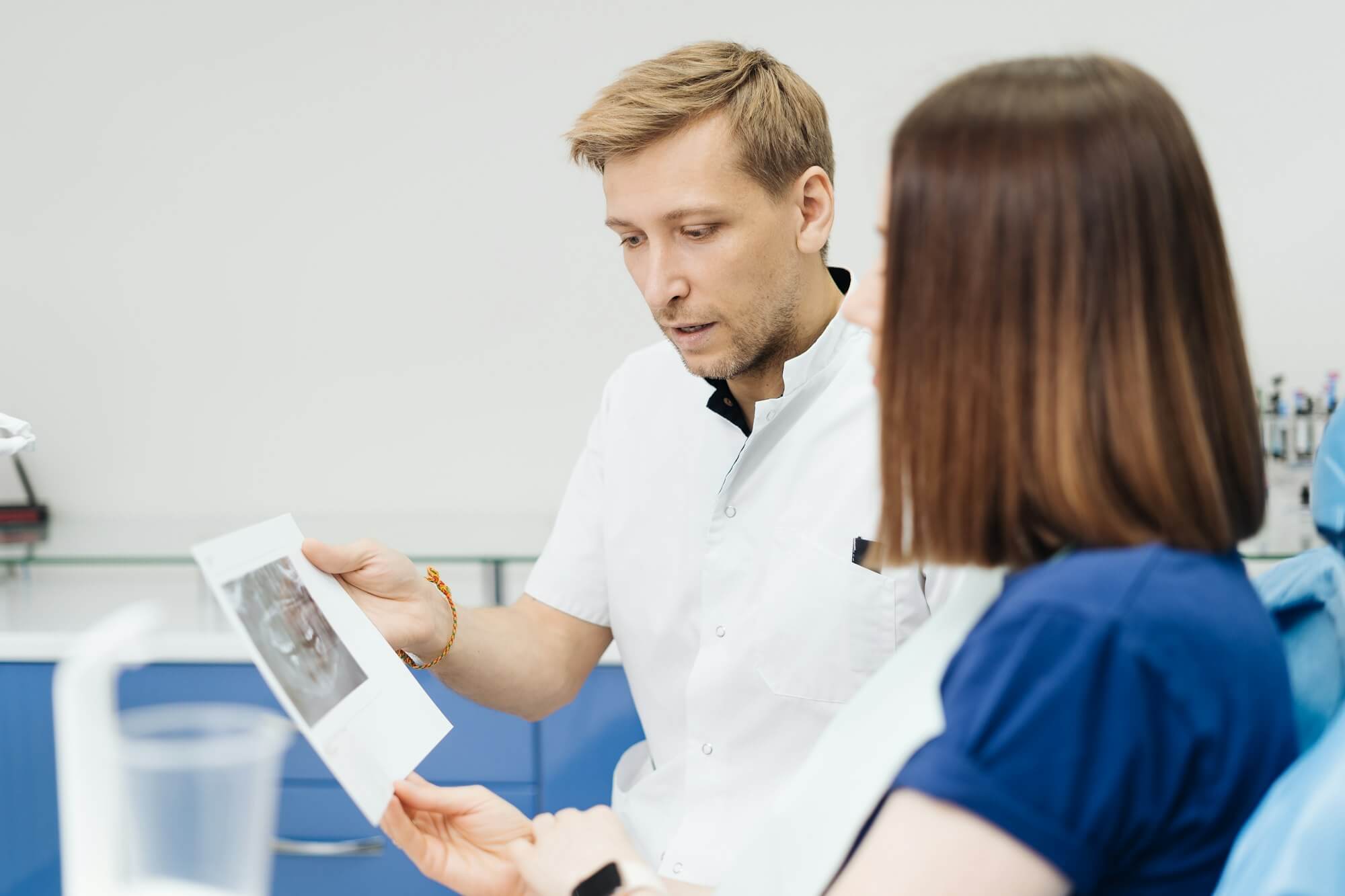 doctor-consulting-his-patient-discussing-tooth-treatment-plan-health-care.jpg